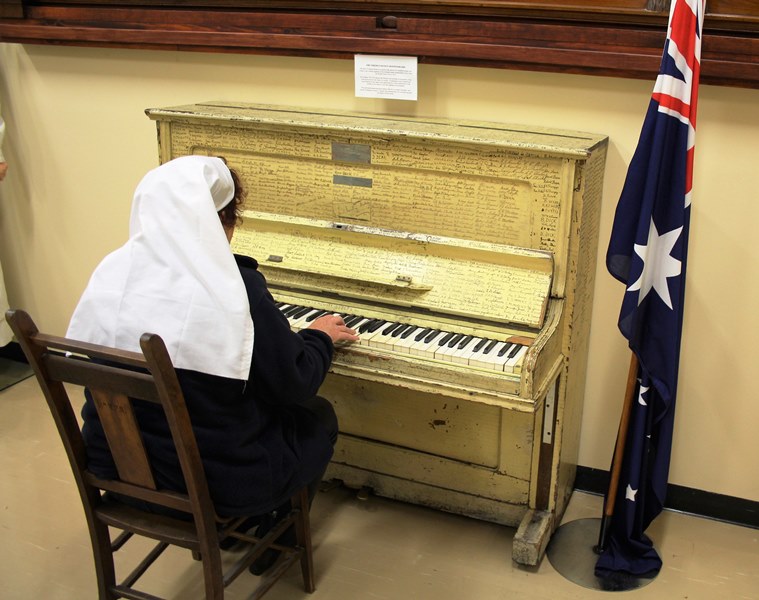 Original piano from Cheer up Hut with signatures of serving men and women